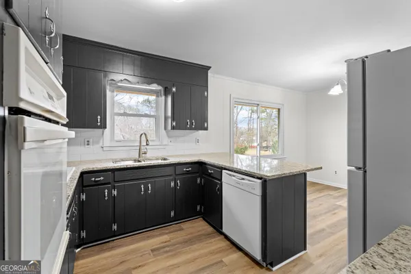 a view of a hallway with wooden floor and entryway