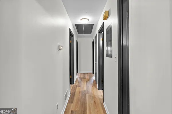 a view of empty room with wooden floor