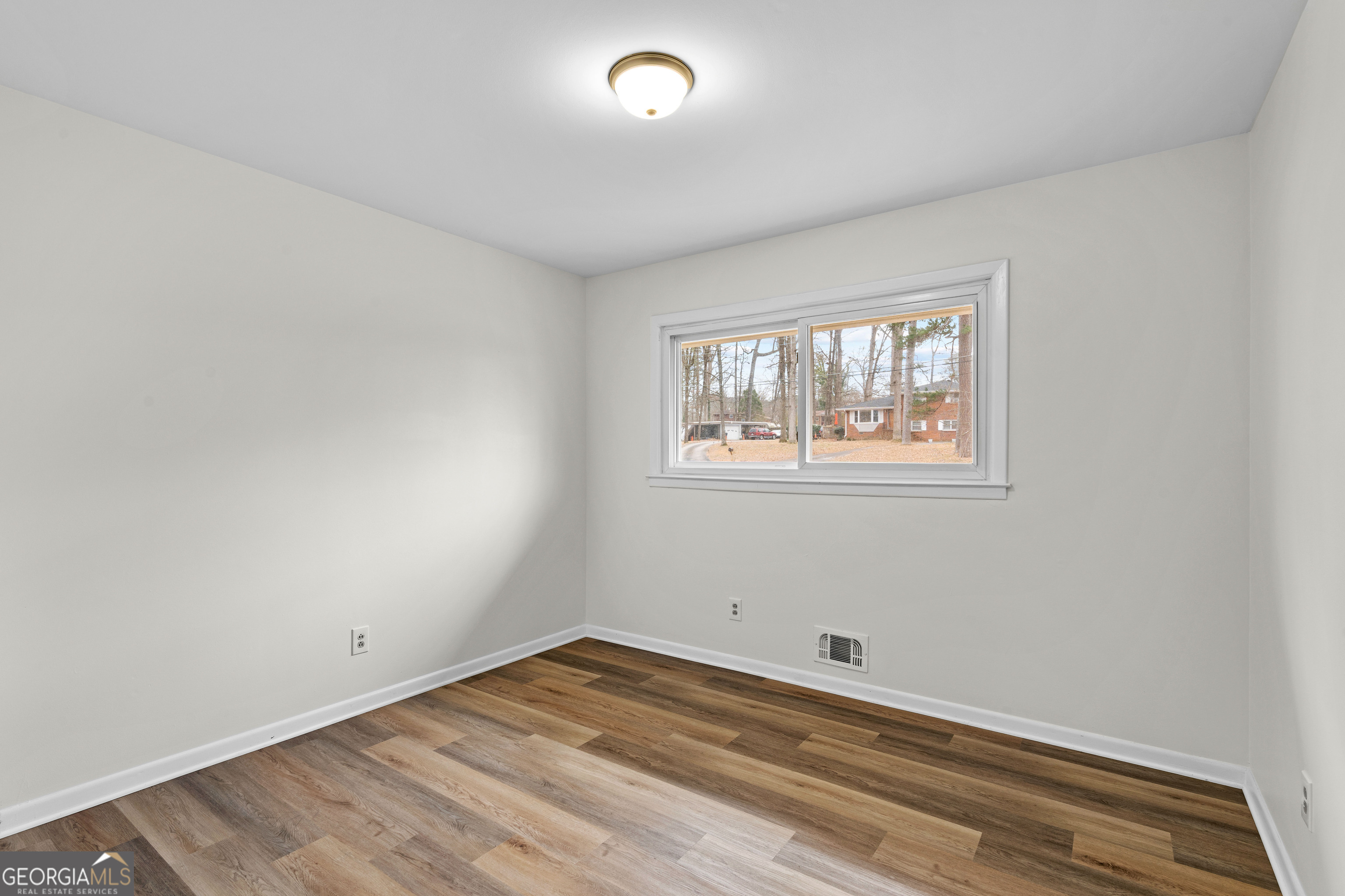 3548 Meadowview Court Rex, GA 30273 - Photo 19 of 41 a view of empty room with wooden floor