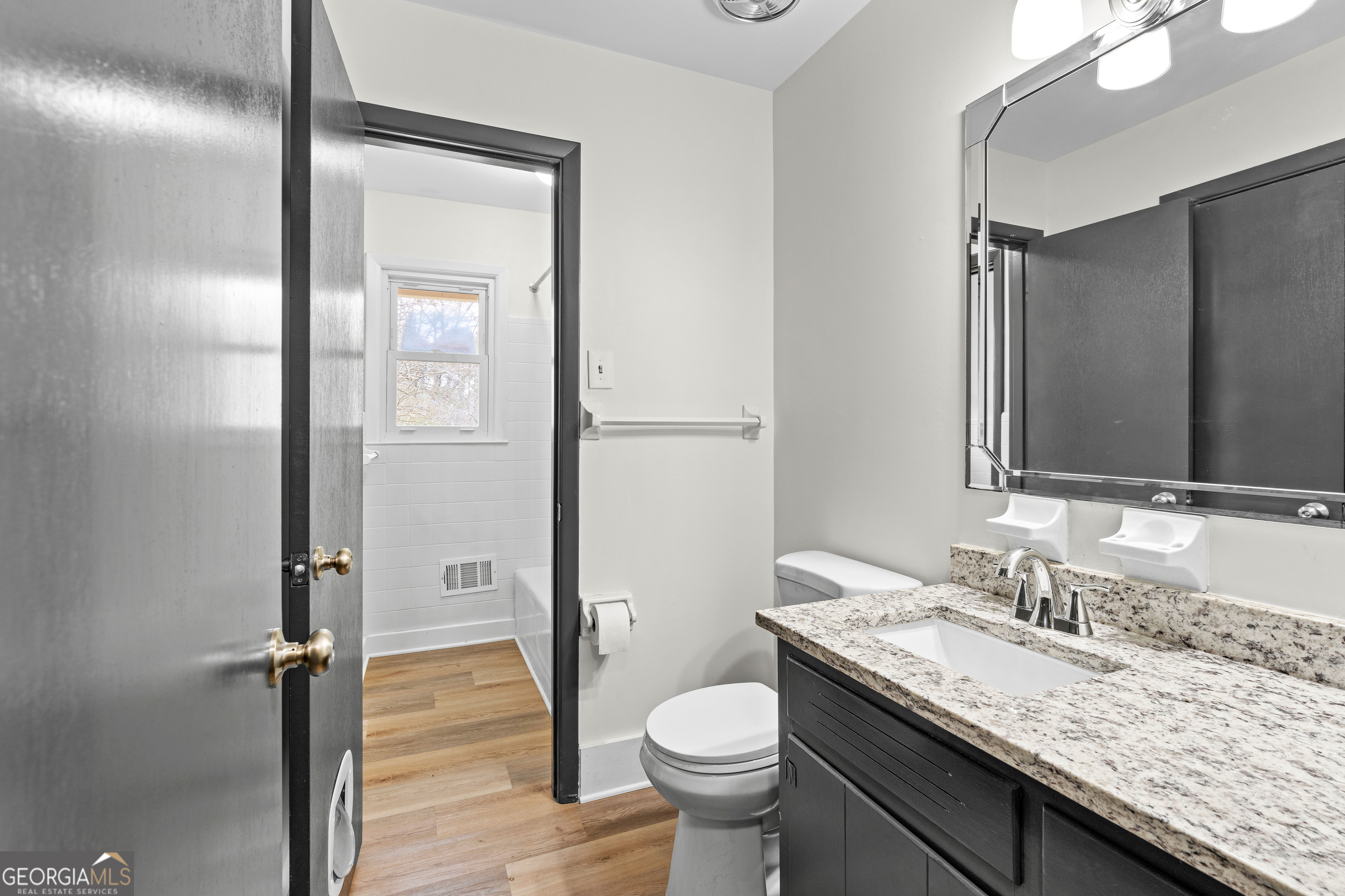3548 Meadowview Court Rex, GA 30273 - Photo 23 of 41 a bathroom with a granite countertop sink toilet and shower