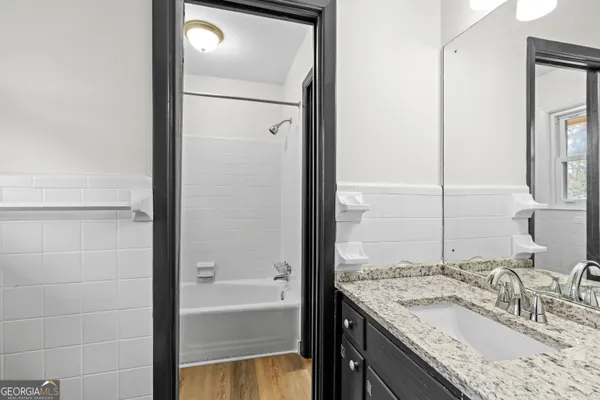 a bathroom with a tub a toilet and a shower