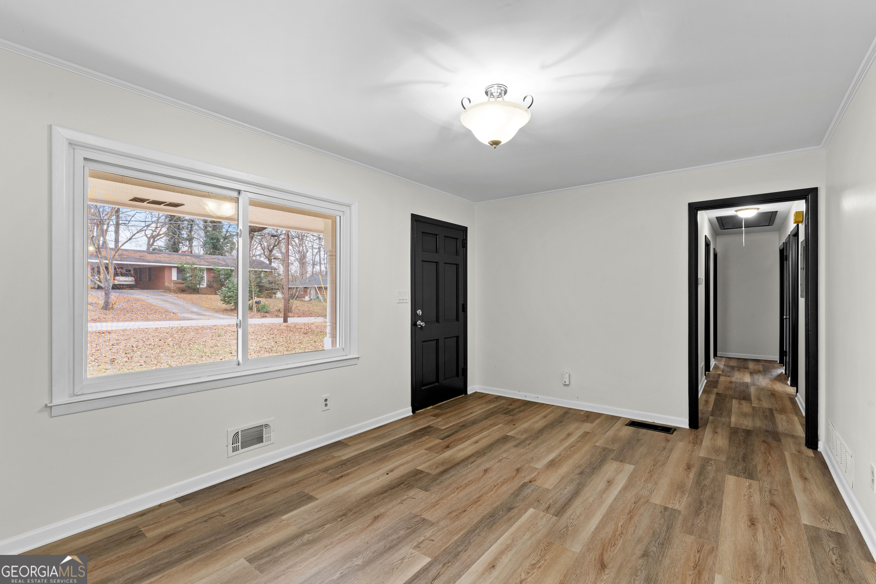 3548 Meadowview Court Rex, GA 30273 - Photo 9 of 41 a view of an empty room with wooden floor and a window