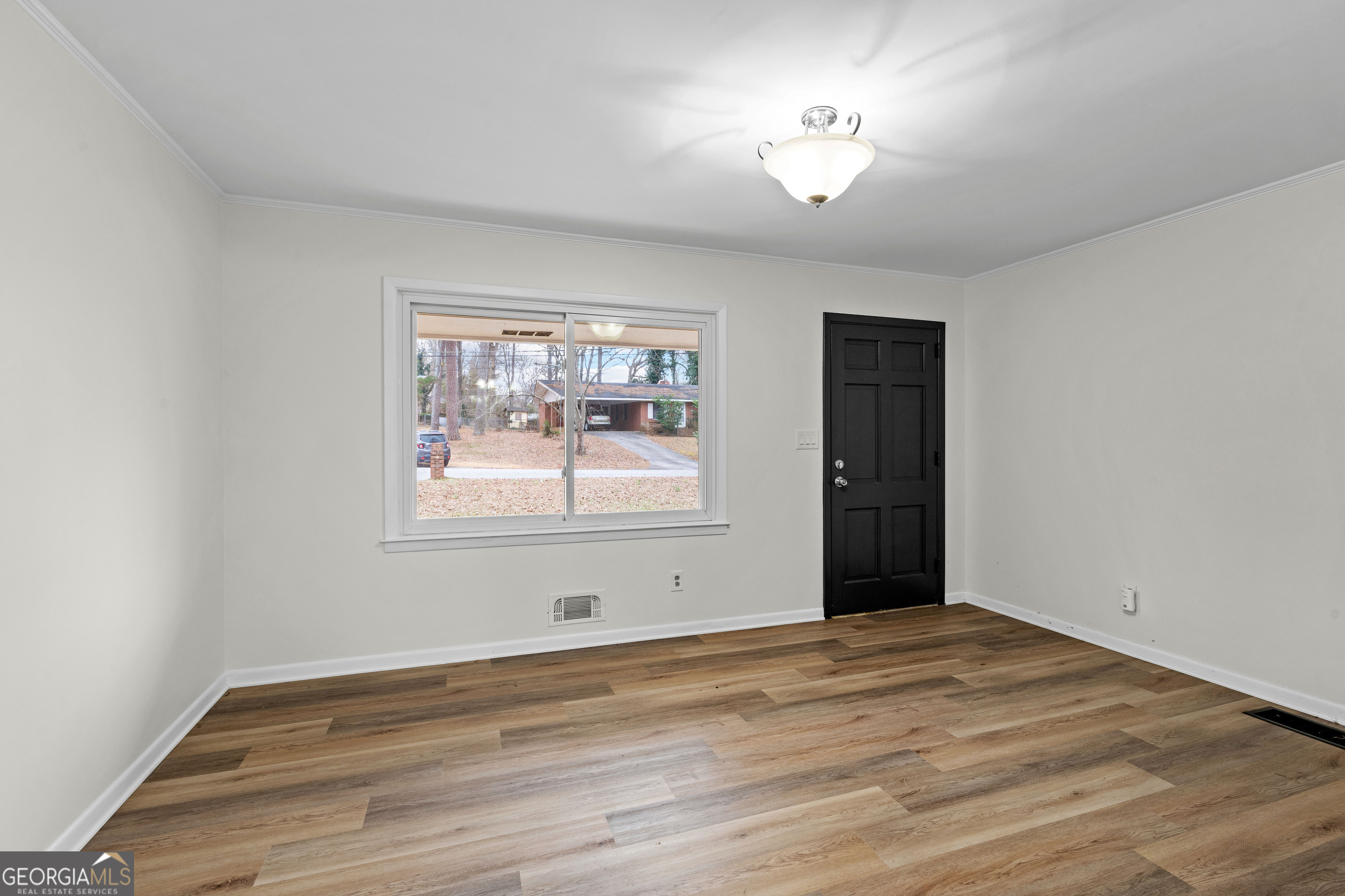 3548 Meadowview Court Rex, GA 30273 - Photo 10 of 41 a view of an empty room with wooden floor and a window