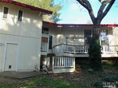 a view of a house with a porch and a bench
