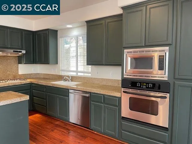 a kitchen with granite countertop a stove and a sink
