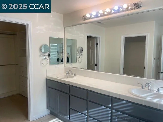 a bathroom with a sink a vanity and a mirror