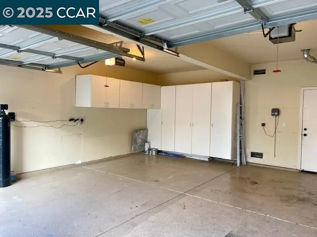 a view of a door and a car parked in front of a house