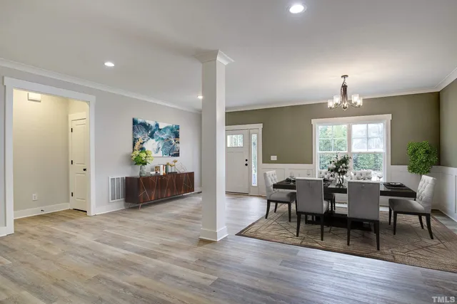 a view of a dining room with furniture and wooden floor
