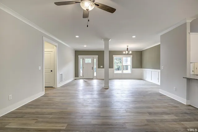 an empty room with a ceiling fan and a ceiling fan