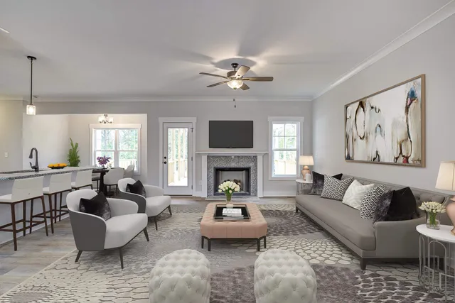 a living room with furniture a fireplace and a large mirror