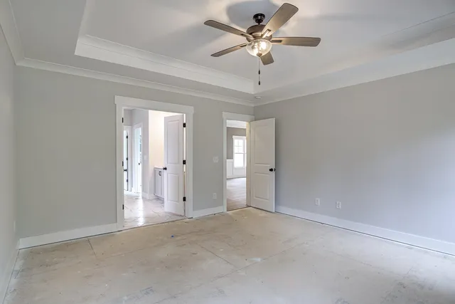 an empty room with windows and entrance door
