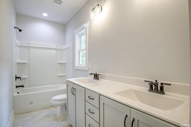 a view of a house with backyard porch and sitting area