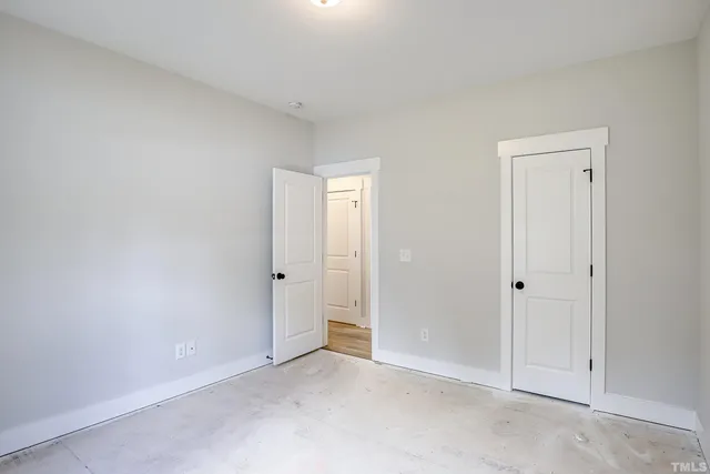 a view of a house with a big yard plants and large trees