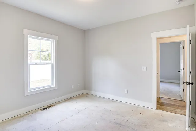 a view of a patio with lawn chairs floor to ceiling window and yard