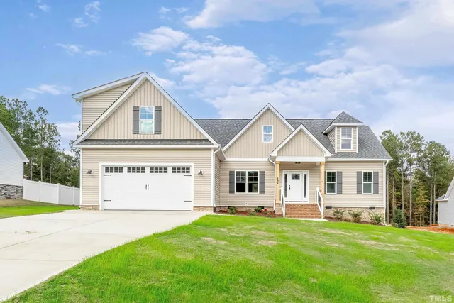 a view of a livingroom with a fireplace wooden floor and chandelier