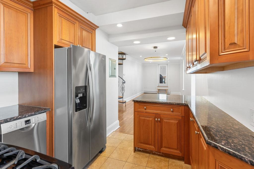422 Grand Street, Unit 3 Hoboken, NJ 07030 - Photo 6 of 28 a kitchen with stainless steel appliances granite countertop a refrigerator and a stove