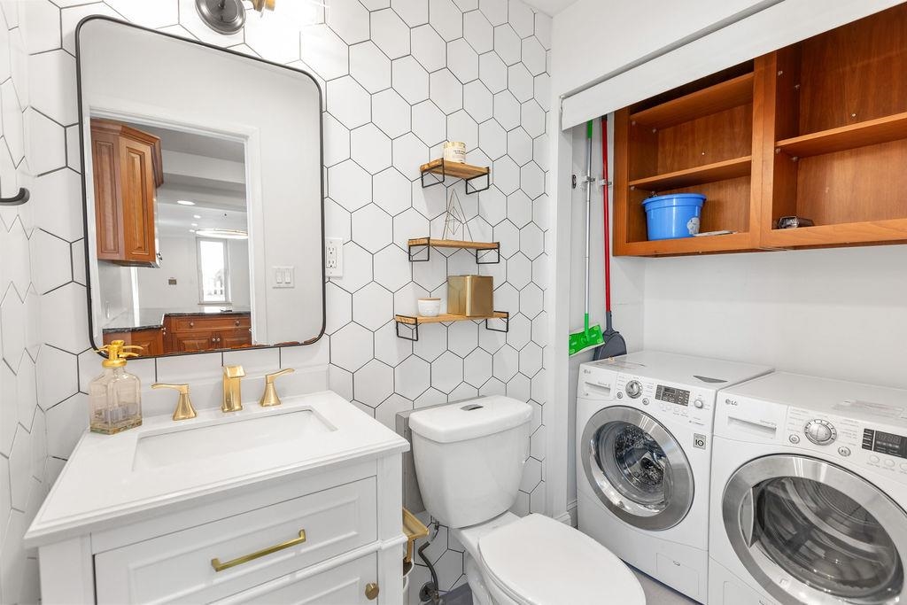 422 Grand Street, Unit 3 Hoboken, NJ 07030 - Photo 8 of 28 a bathroom with a sink mirror and toilet