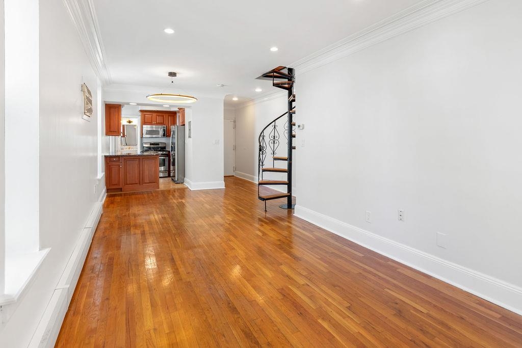 422 Grand Street, Unit 3 Hoboken, NJ 07030 - Photo 9 of 28 a view of empty room with wooden floor