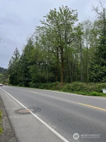 a view of a road with a trees park on the side of the road