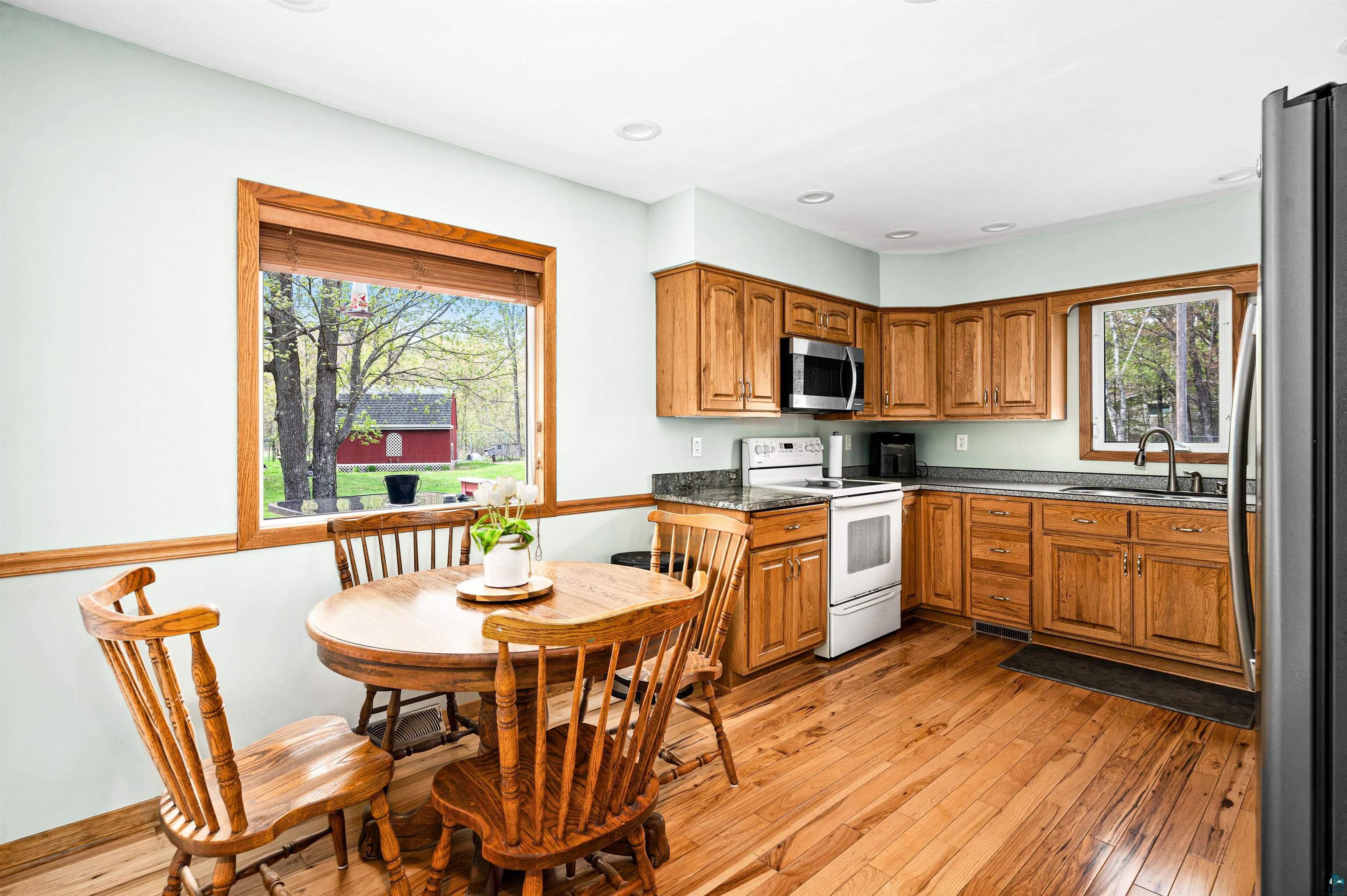 6908 Morris Thomas Road Cloquet, MN 55720 - Photo 15 of 41 Kitchen with appliances with stainless steel finishes, light hardwood / wood-style floors, and sink