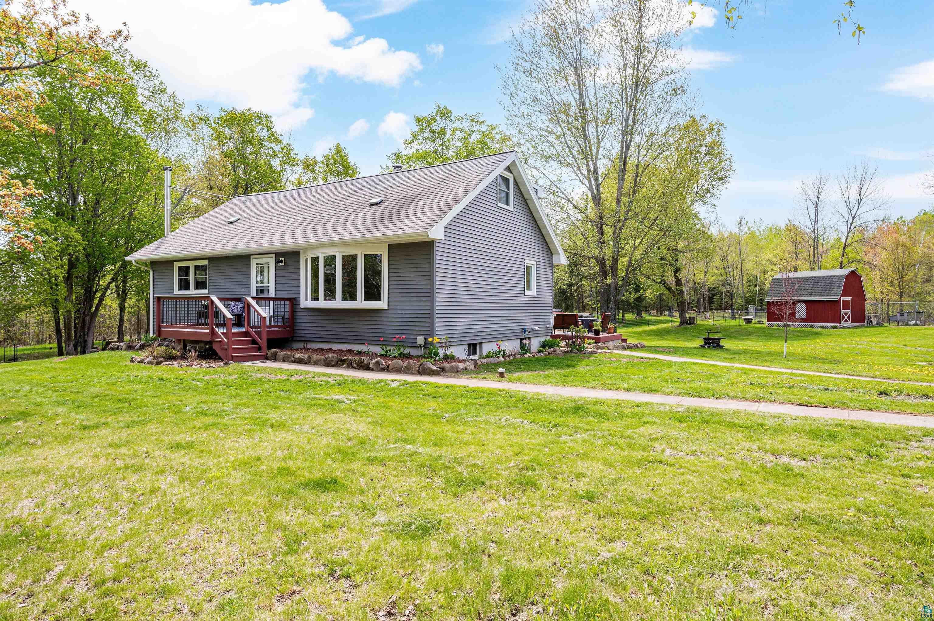 Exterior space featuring a wooden deck and a yard
