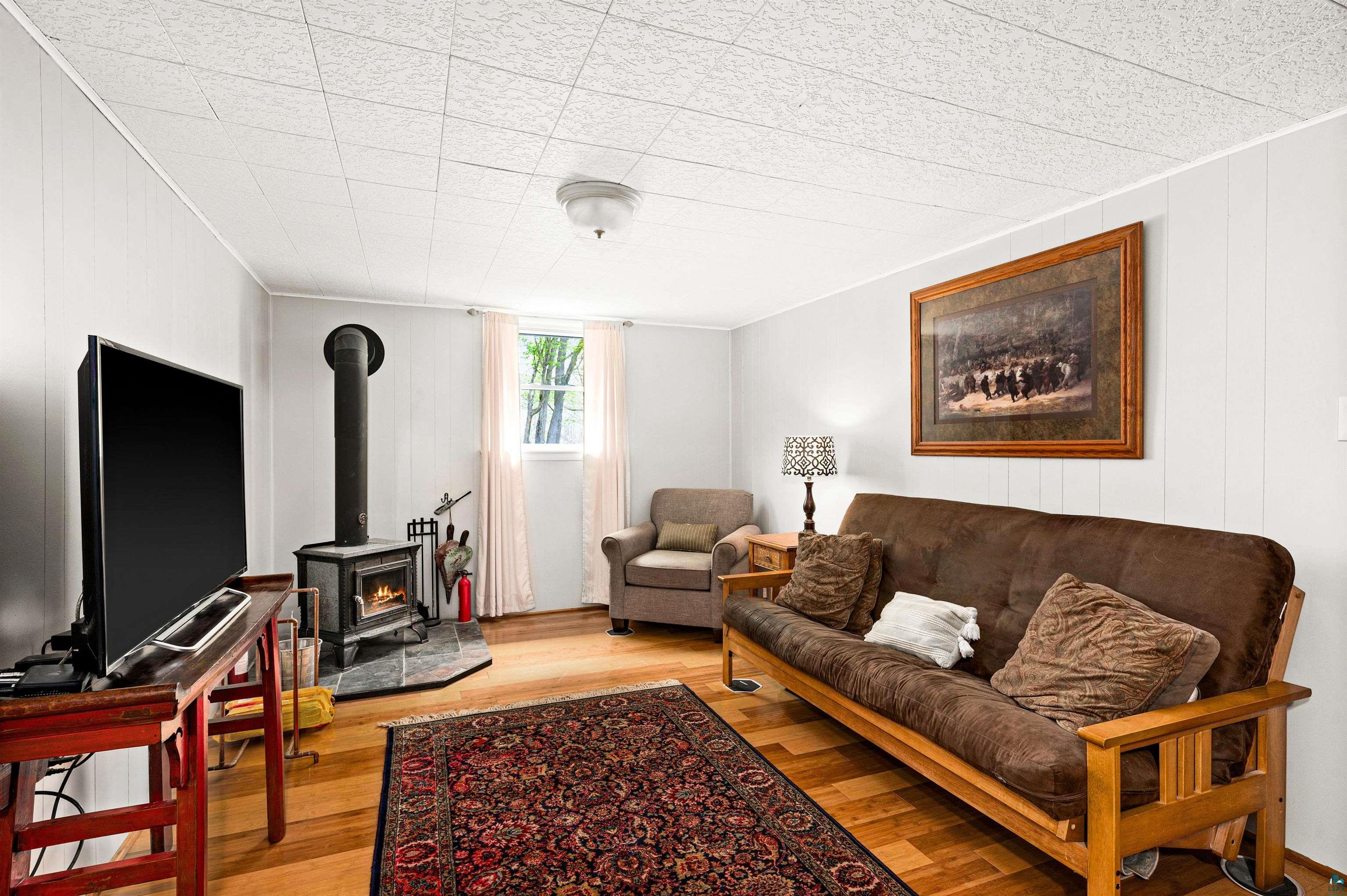 6908 Morris Thomas Road Cloquet, MN 55720 - Photo 33 of 41 Living room with a wood stove and hardwood / wood-style floors