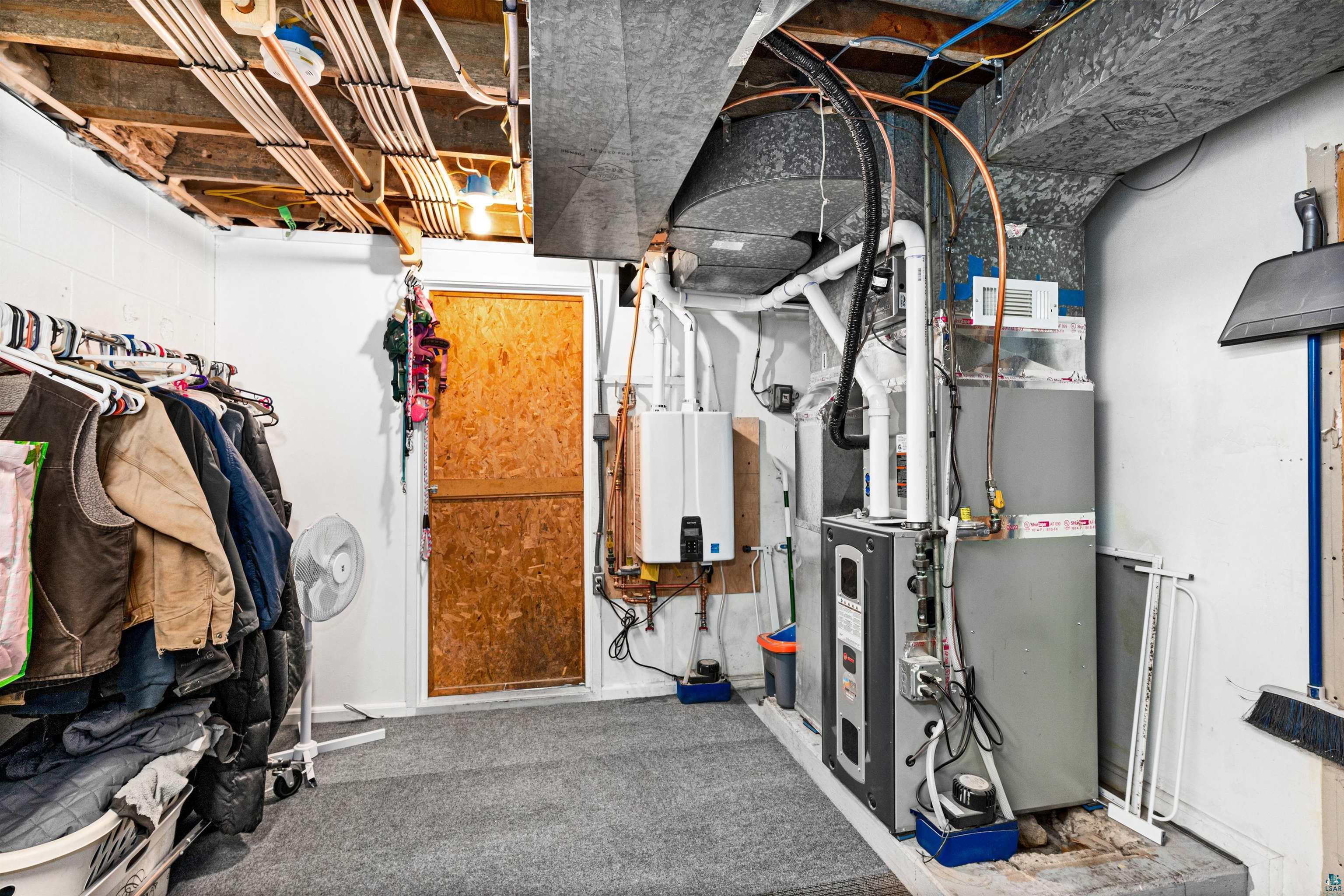 6908 Morris Thomas Road Cloquet, MN 55720 - Photo 39 of 41 Utility room featuring gas water heater and heating utilities