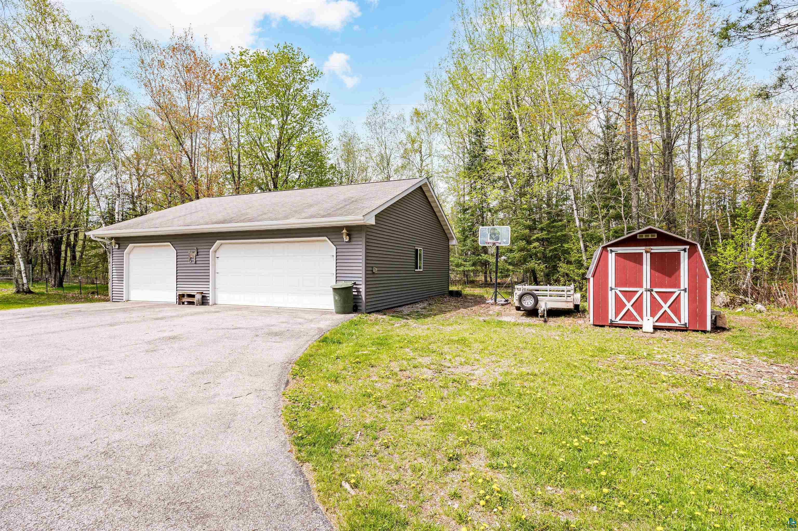 Exterior space featuring a shed and a garage