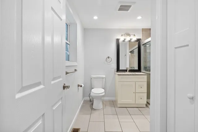 an empty room with wooden floor and a ceiling fan