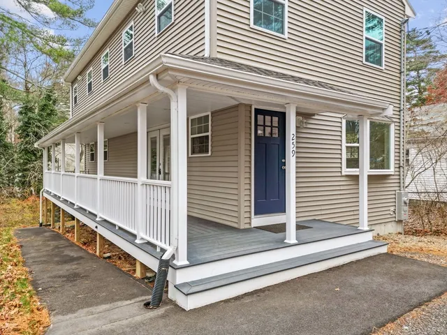 a view of a house with a large window and stairs