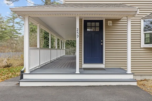 a kitchen with stainless steel appliances granite countertop a refrigerator a sink dishwasher a stove top oven a refrigerator and white cabinets with wooden floor