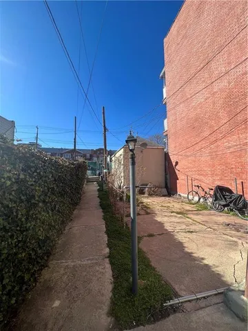 a view of a street with wooden fence