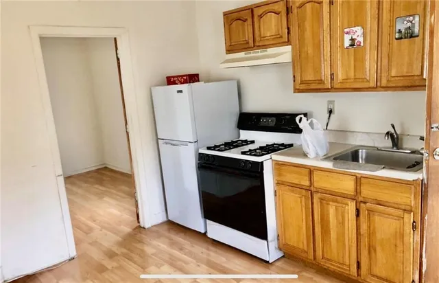 a kitchen with granite countertop a refrigerator and a stove