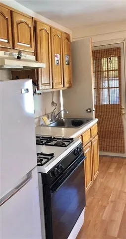 a kitchen with stainless steel appliances granite countertop a stove and a refrigerator