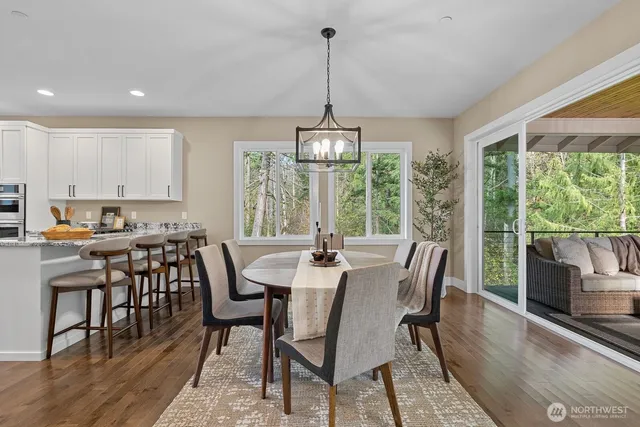 a view of a dining room with furniture window and wooden floor