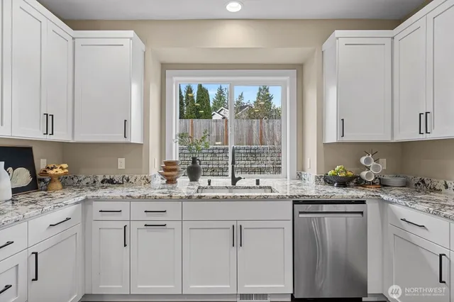 a kitchen with a sink stove and cabinets