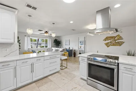 a kitchen with stove a sink and a refrigerator