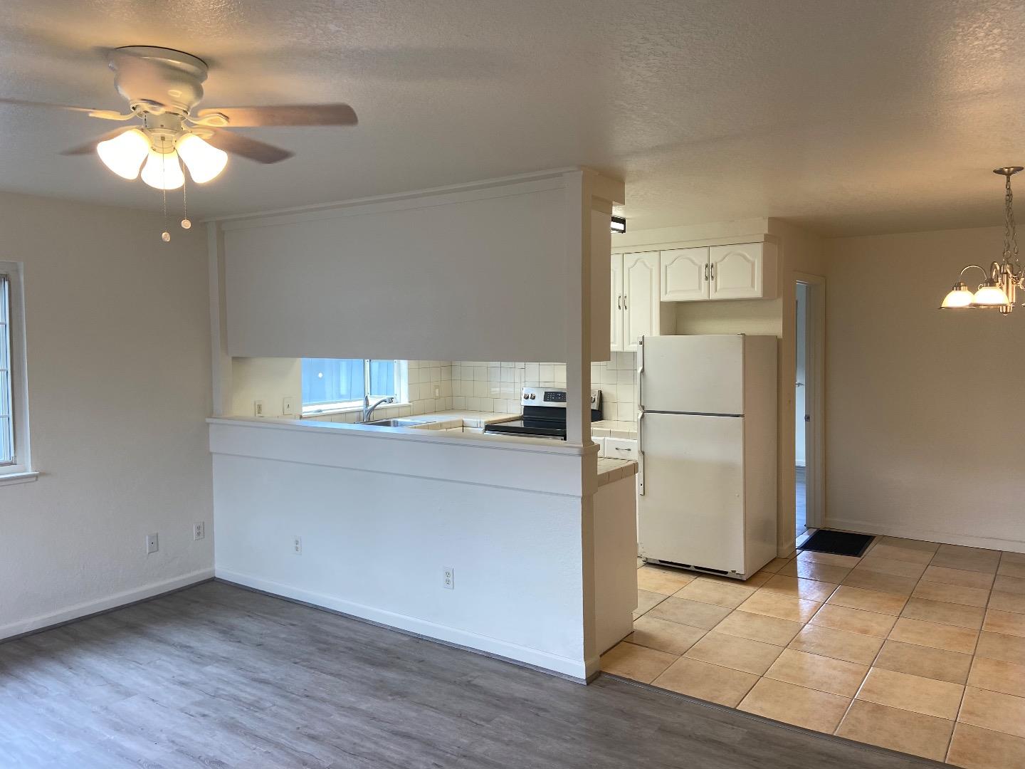 1693 Goodwin Street Seaside, CA 93955 - Photo 11 of 43 a kitchen with a refrigerator and a stove top oven