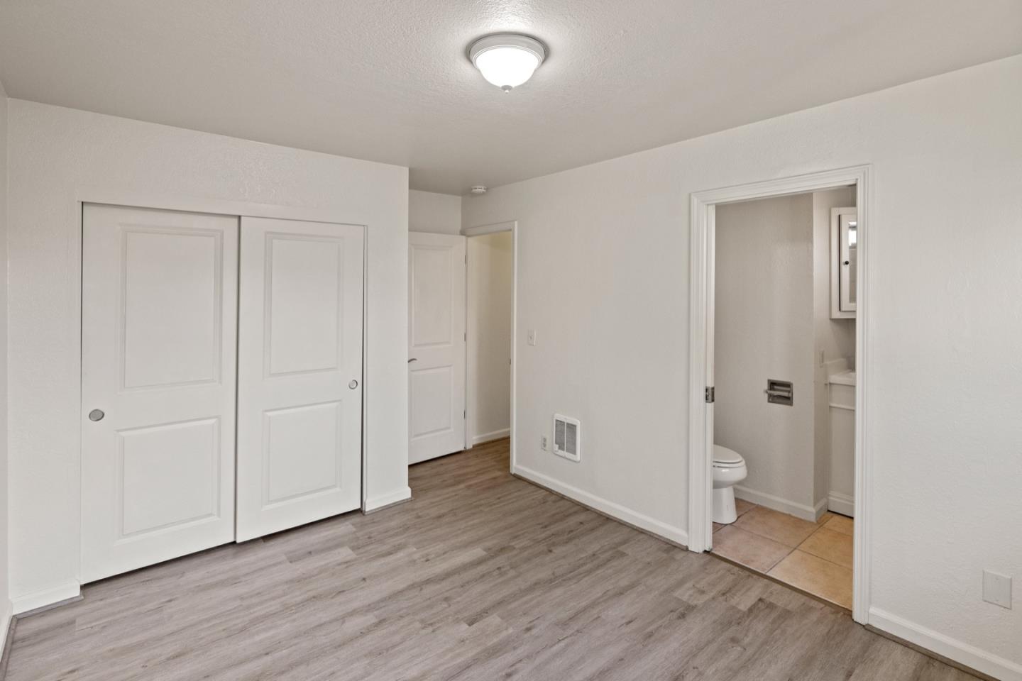 1693 Goodwin Street Seaside, CA 93955 - Photo 17 of 43 an empty room with wooden floor and closet area