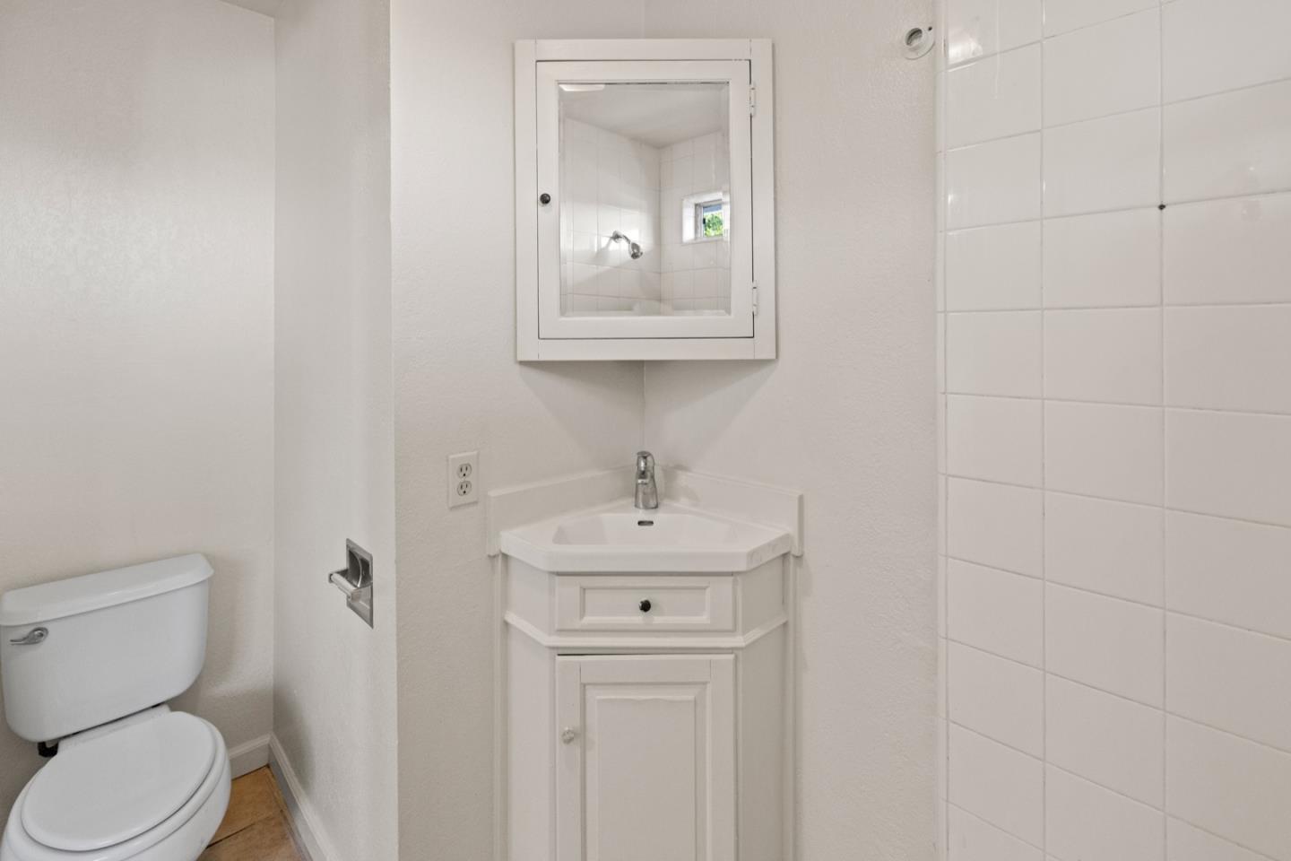 1693 Goodwin Street Seaside, CA 93955 - Photo 19 of 43 a bathroom with a toilet a sink and mirror