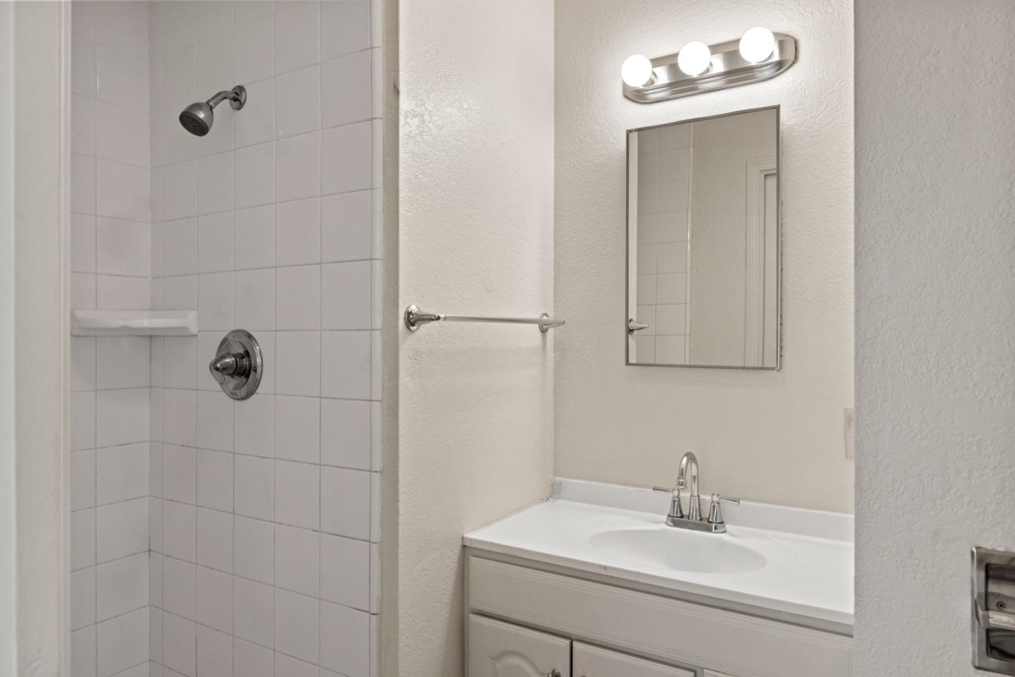 1693 Goodwin Street Seaside, CA 93955 - Photo 24 of 43 a bathroom with a sink a mirror and vanity