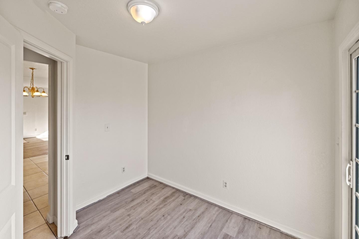 1693 Goodwin Street Seaside, CA 93955 - Photo 28 of 43 a view of an empty room with wooden floor and a window