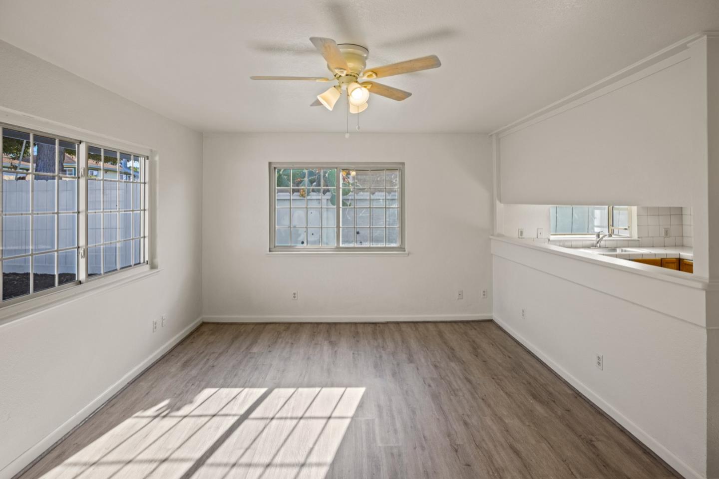 1693 Goodwin Street Seaside, CA 93955 - Photo 7 of 43 a view of an empty room with a window and wooden floor
