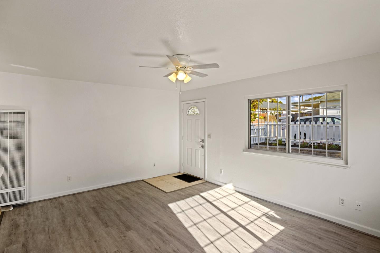 1693 Goodwin Street Seaside, CA 93955 - Photo 8 of 43 wooden floor in an empty room with a window