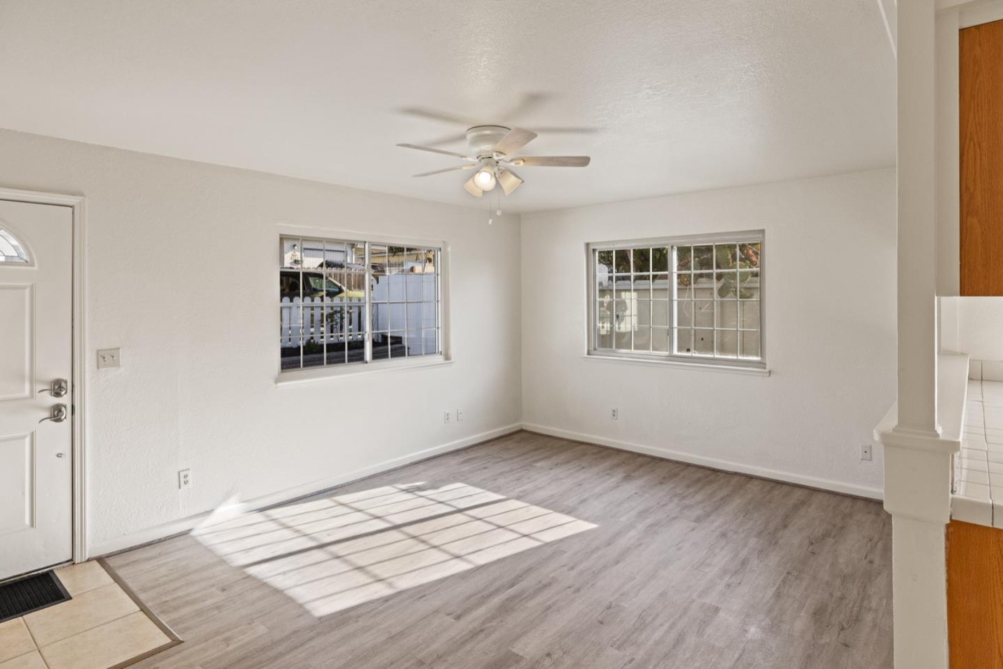 1693 Goodwin Street Seaside, CA 93955 - Photo 9 of 43 a view of an empty room with a window and wooden floor