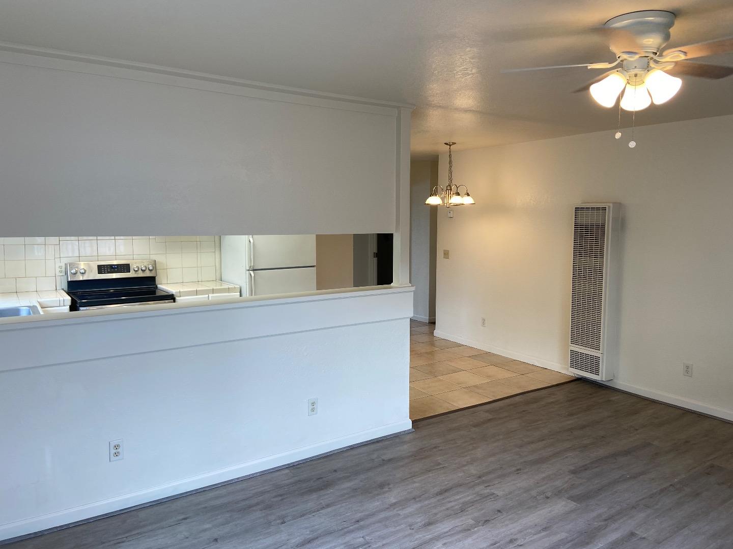 1693 Goodwin Street Seaside, CA 93955 - Photo 10 of 43 a kitchen with a wooden floor and a cabinet