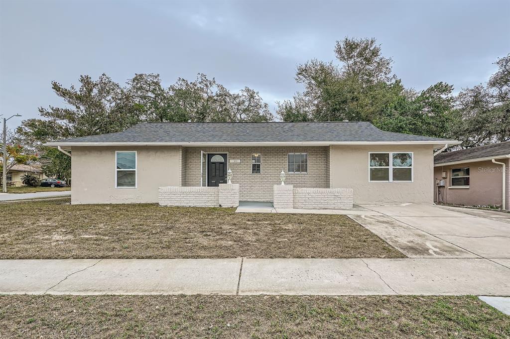 11606 Nature Trail Port Richey, FL 34668 - Photo 1 of 1 a front view of a house with a garden