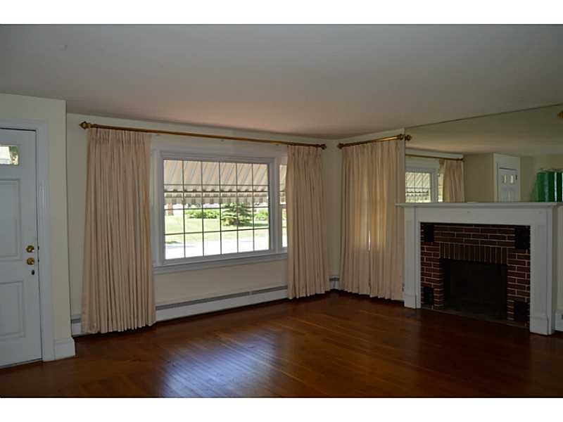 7 Sir Charles Road Lincoln, RI 02865 - Photo 15 of 23 Living Room. Large living room with brick fireplace and hardwoods