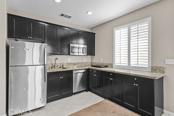 23347 Crystal Way Wildomar, CA 92595 - Photo 10 of 29 a kitchen with stainless steel appliances granite countertop a sink a stove a refrigerator and cabinets