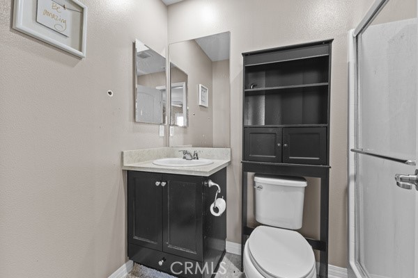 23347 Crystal Way Wildomar, CA 92595 - Photo 12 of 29 a bathroom with a toilet a sink and mirror